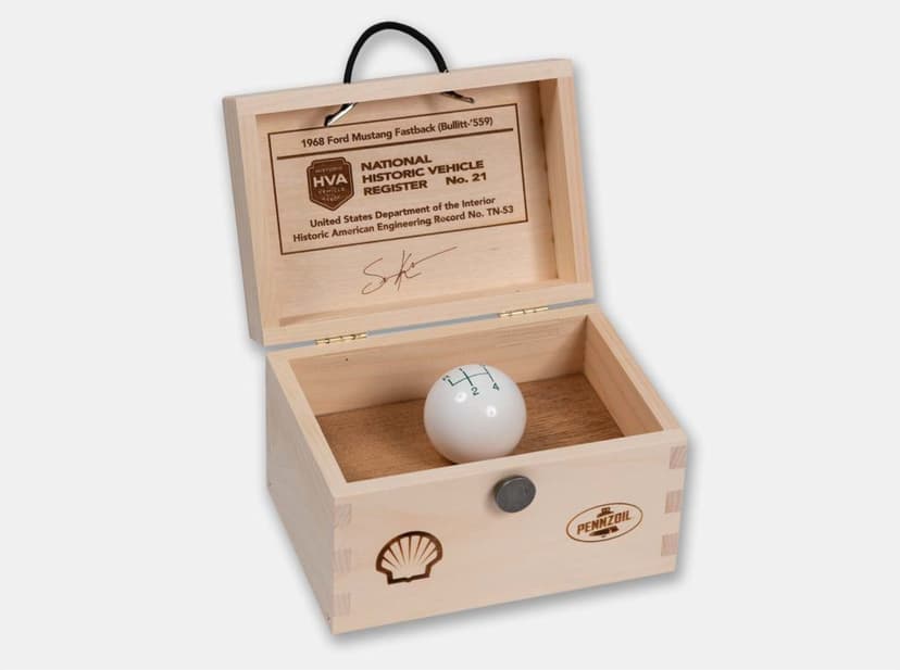 Open dovetailed keepsake box with a laser-engraved lid holding a white shift knob from the 1968 Ford Mustang Bullitt