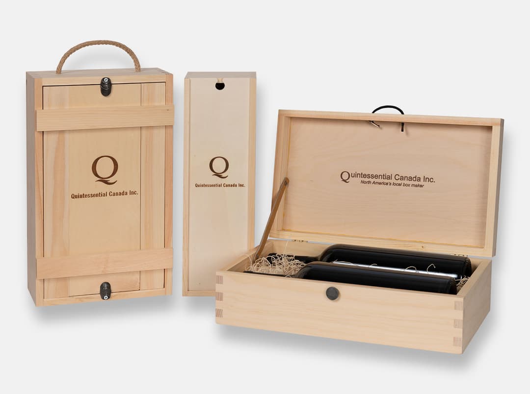 Unstained pine wine boxes branded with the Quintessential Canada logo, including a two-bottle box with a rope handle