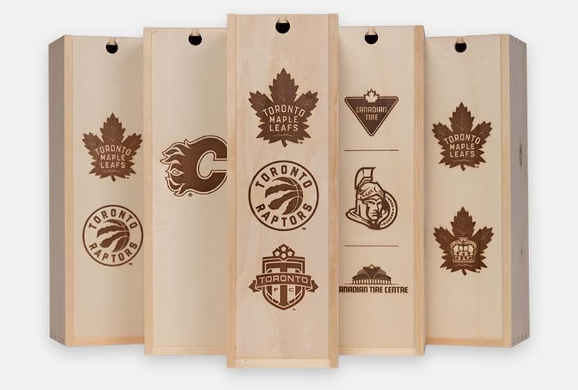 Five pine wine boxes branded with NHL, NBA and MLS team logos including the Toronto Maple Leafs, Calgary Flames, Toronto Raptors and Ottawa Senators