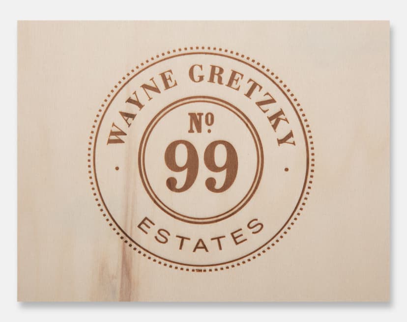 Close-up of the Wayne Gretzky No. 99 Estates logo branded into pine